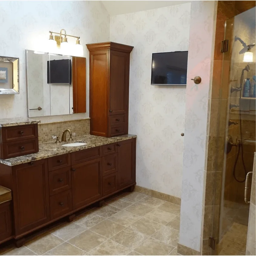 A long bathroom vanity with dark wood cabinets, a granite countertop, and tile flooring.