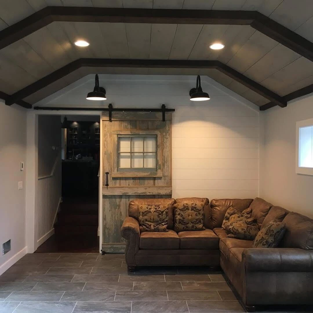 A cozy living room featuring a comfortable couch and an open door leading to another room.