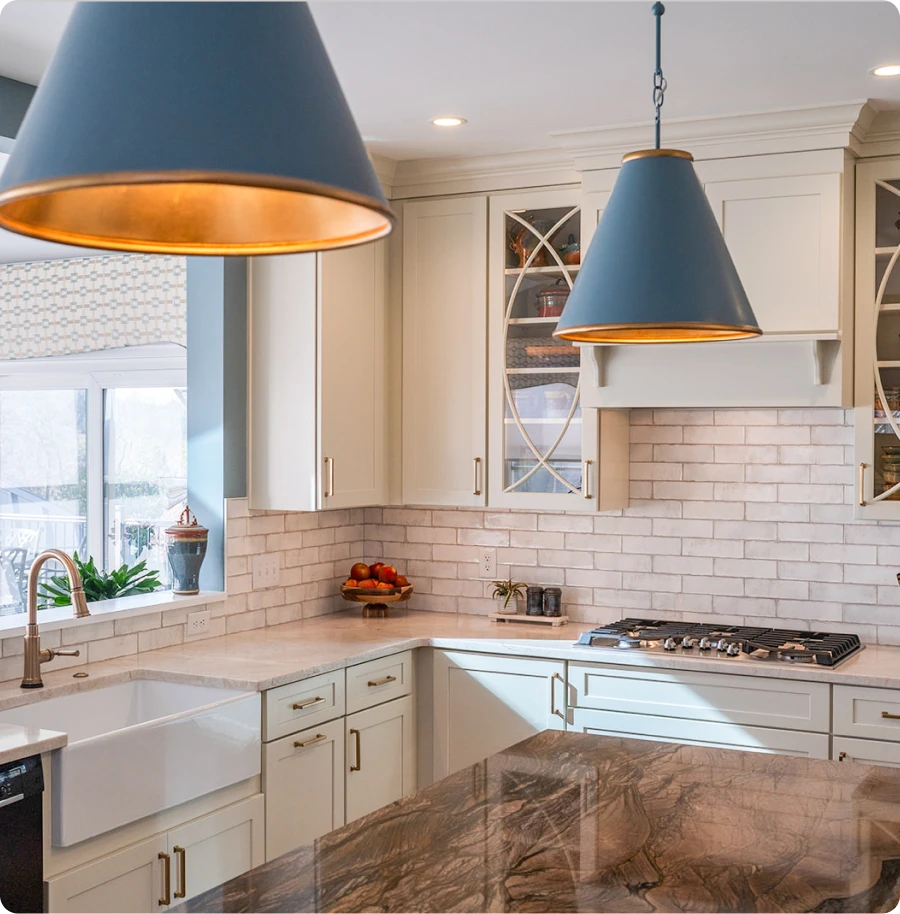 Modern kitchen featuring stylish pendant lights illuminating the countertop and dining area.